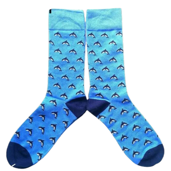 Pair of socks lying flat on white background. Socks have navy toe and heel, light blue body, and are covered with mini navy dolphins.